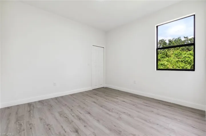 Empty room featuring light wood finished floors and baseboards