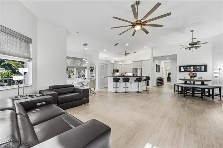 Soaring 13-foot ceilings elevate this expansive open-concept living space, beautifully enhanced by fresh interior paint.