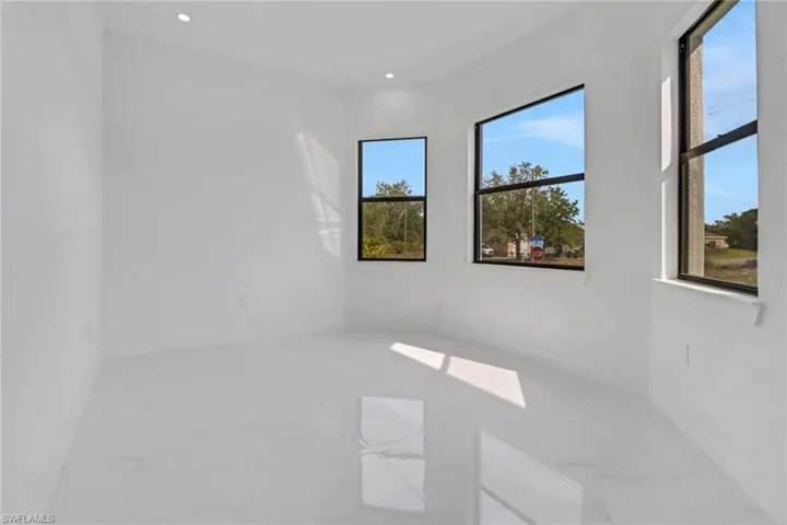 Spare room featuring marble finish floor and recessed lighting