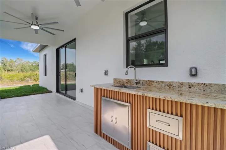 View of patio with a sink and ceiling fan