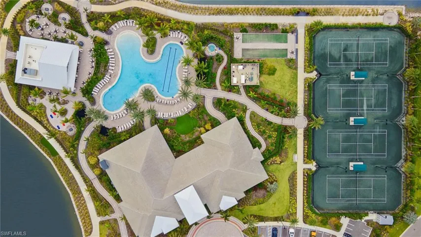 Aerial view of amenity center, tennis courts, bocce, resort pool, Bahama Bar, lake,