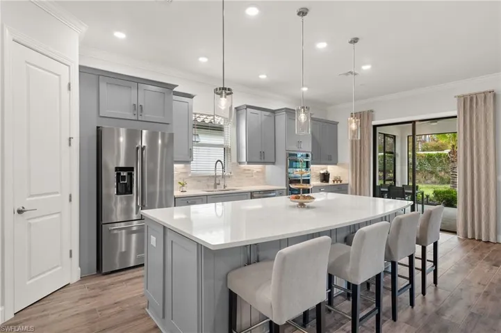 Kitchen featuring a center island, stainless steel appliances, and pendant lighting