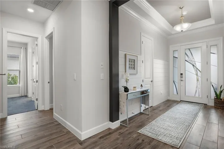 Foyer with crown molding, tray ceiling