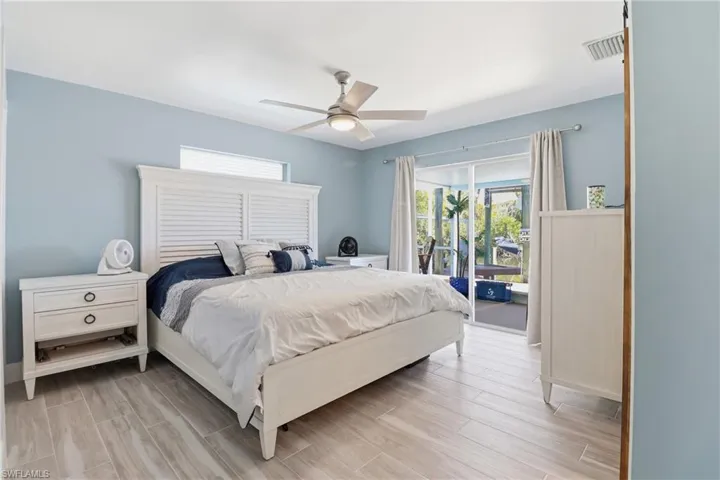 Primary Bedroom walkout to enclosed sunroom/pool.