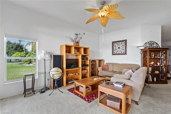 Living room featuring carpet flooring and ceiling fan