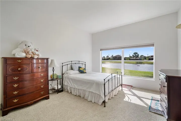 Carpeted bedroom featuring a water view
