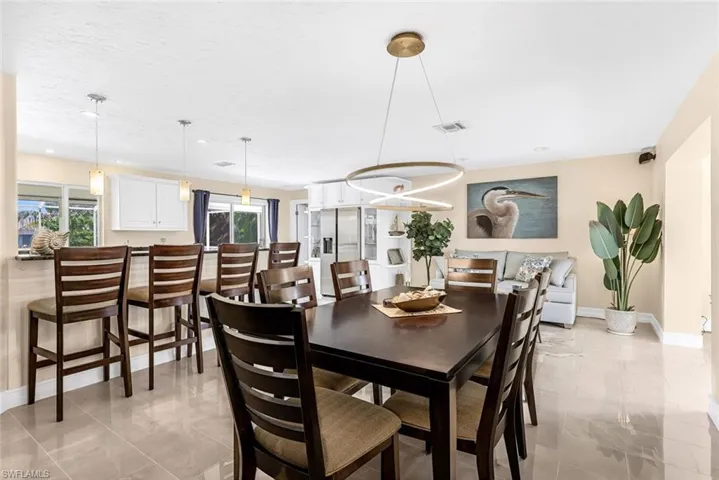 Dining space featuring plenty of natural light and light tile patterned floors