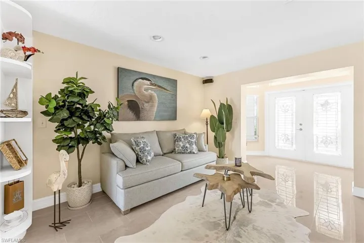 Living room with tile patterned floors and french doors