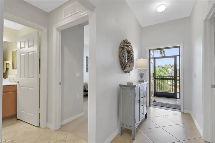 Entryway with light tile patterned floors