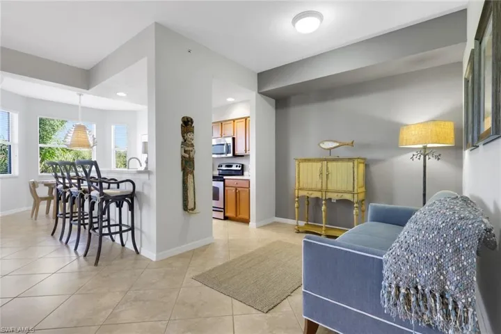 Living area with baseboards and light tile patterned flooring