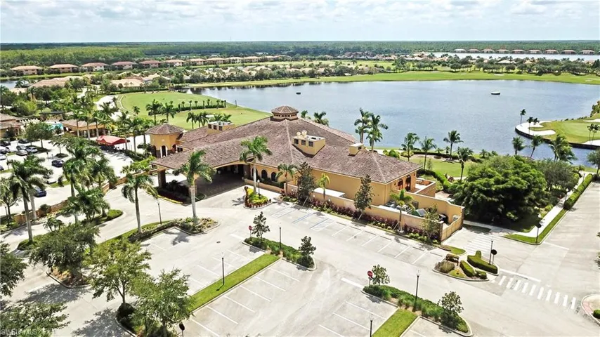 Aerial perspective of suburban area featuring a large body of water and a golf club