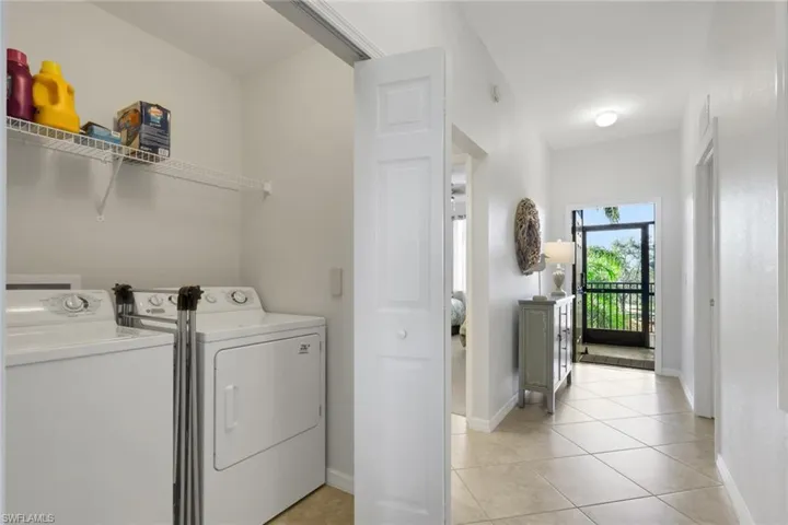Laundry area featuring washer and dryer and light tile patterned flooring