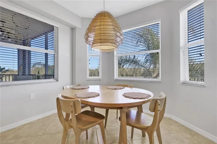 Dining space featuring plenty of natural light and light tile patterned floors