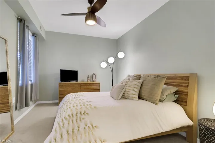 Primary bedroom with baseboards and ceiling fan