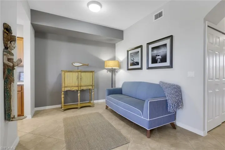 Sitting room featuring light tile patterned floors and baseboards