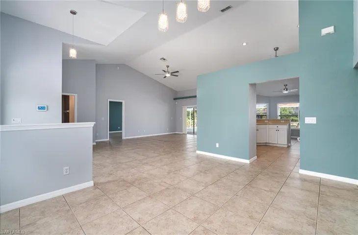 Dining room looking into living area and kitchen.