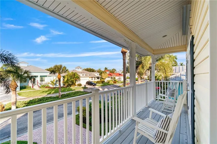 2nd floor open Balcony composite deck featuring a full front tropical neighborhood view.