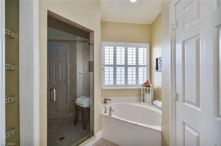 Bathroom featuring a bath and a stall shower