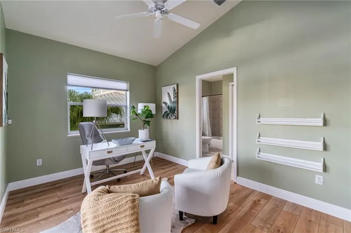 Office featuring light wood-style floors, a ceiling fan, and high vaulted ceiling