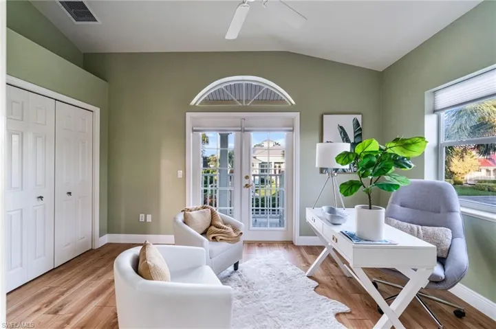 Office featuring french doors, vaulted ceiling, healthy amount of natural light, wood finished floors, and a ceiling fan