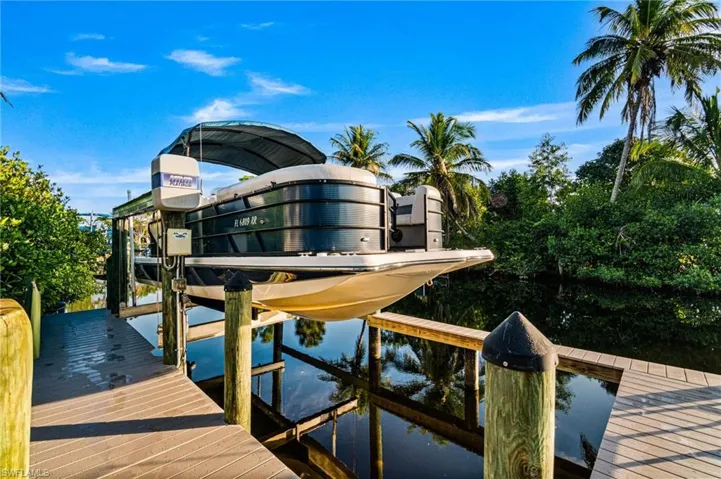 Dock area featuring a 13,000 LB boat lift that can fit a 30 foot center console.