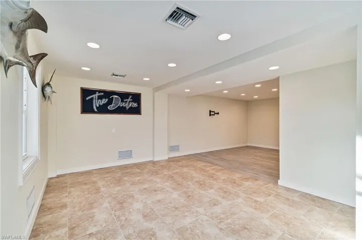Unfurnished BONUS room with recessed lighting IS CONCRETE BLOCK WITH SHEET ROCK FINISH AND TILE FLOORS FOR DURABILITY. CAN BE A GREAT GAME AREA WITH LIVING SPACE