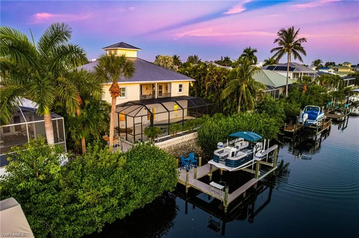 WATERFRONT 2-story home with EASY GULF ACCESS (80 ft wide / 6-8 ft deep river canal) The Dock boasts a 13,000 lbs boat lift.