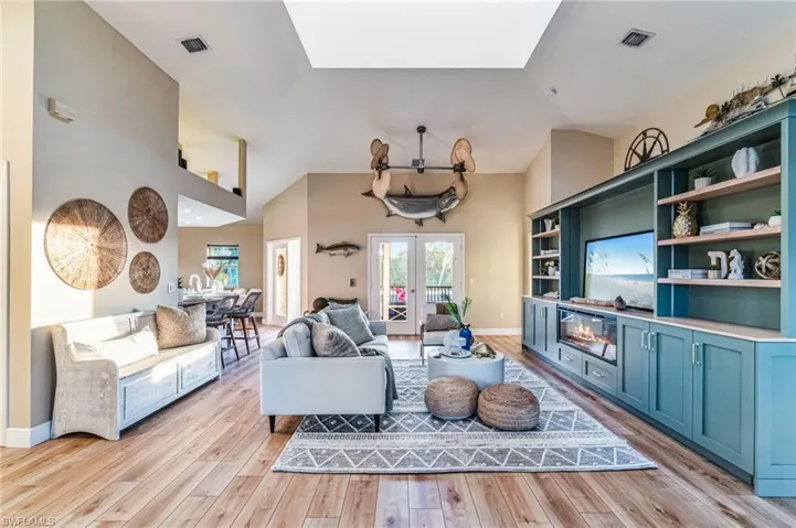 Bright, open living space ideal for gathering and entertaining and French Doors leading out to the screened in lanai