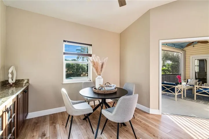 Dining room featuring vaulted ceiling and light wood-style flooring