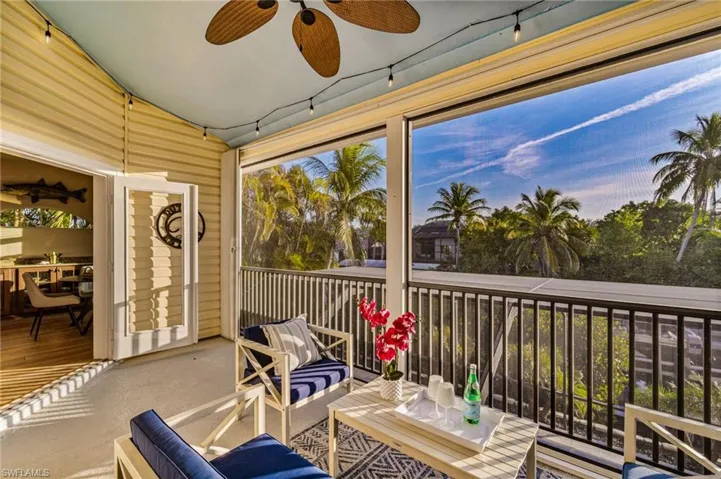 French Doors from the dining area open up to the 2nd floor screened in sitting area - overlooking the peaceful canal water...