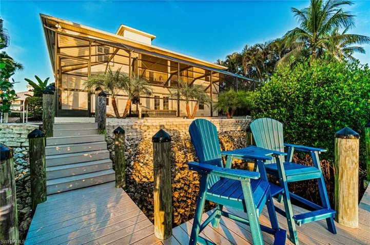 Peaceful waterfront, setting with power boat, dock, and jet ski area with fish, cleaning and relaxation tricks decking areas leading up past the sea wall to the extensive rear entertaining.