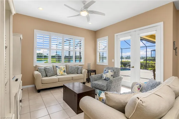 Living room with ceiling fan and light tile patterned floors
