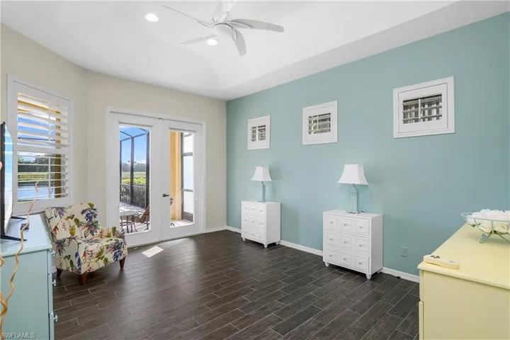Sitting room with french doors, dark hardwood / wood-style flooring, and ceiling fan