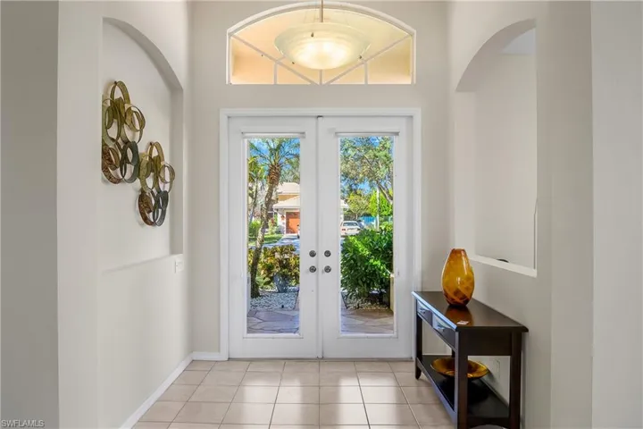 Doorway featuring light tile patterned floors and french doors