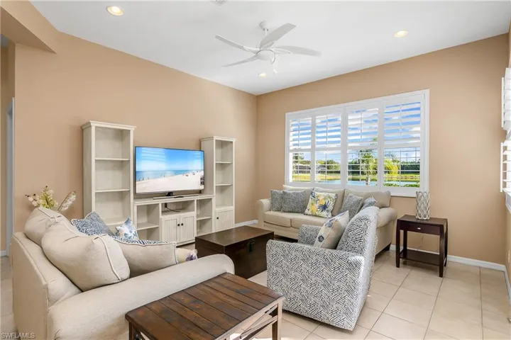 Living room featuring ceiling fan and light tile patterned floors
