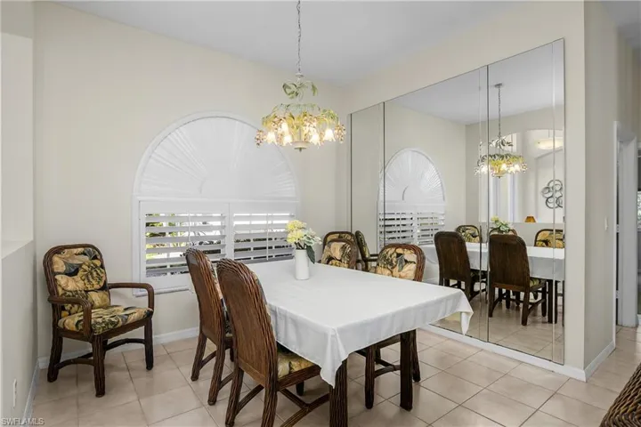 Tiled dining room with a notable chandelier