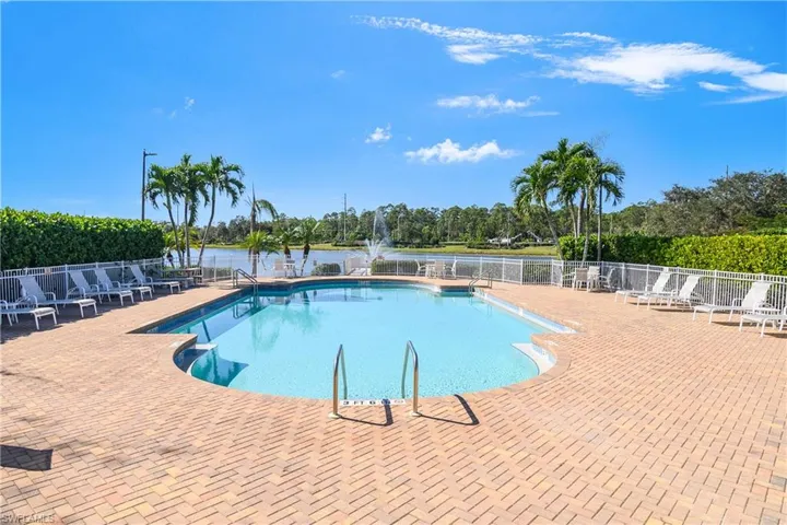 View of pool with a water view and a patio
