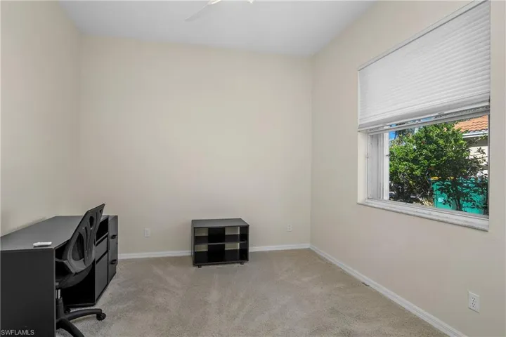 Carpeted office space with ceiling fan