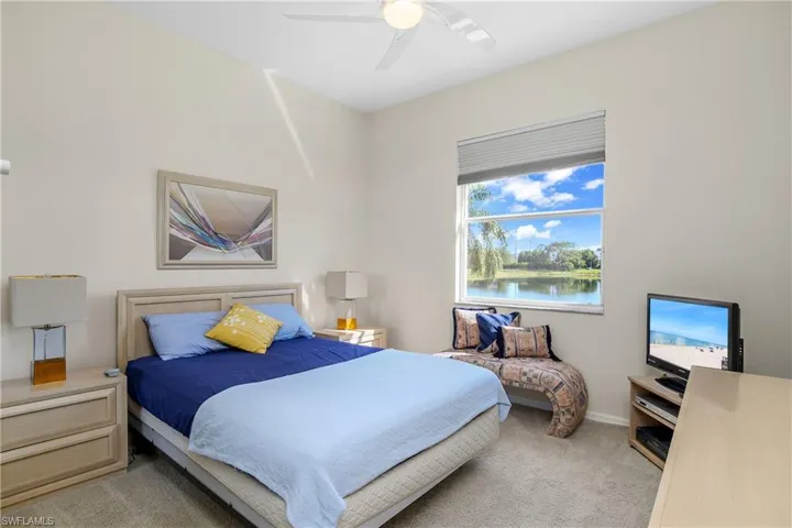 Bedroom featuring light carpet and ceiling fan