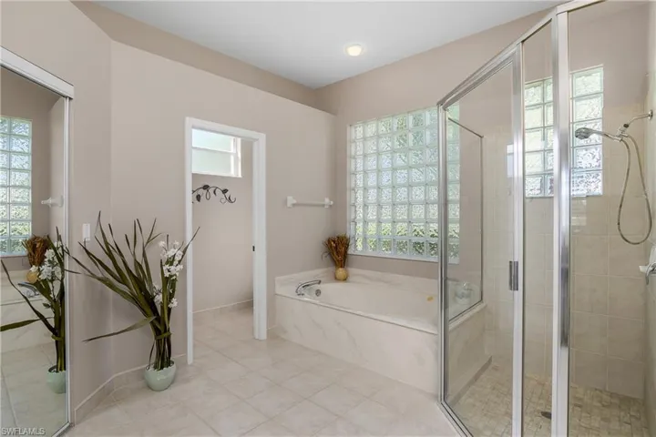 Bathroom featuring tile patterned floors and separate shower and tub