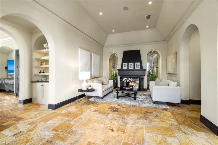 Community lobby featuring ornamental molding, recessed lighting, and lofted ceiling