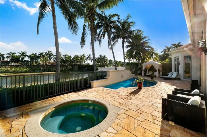 View of swimming pool featuring a gazebo, an in-ground hot tub, a patio area, and a water view