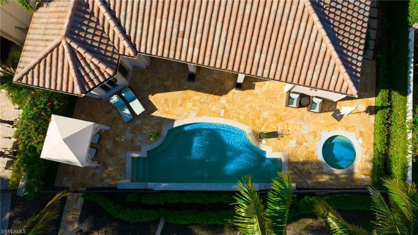 Aerial view of property and surrounding area with a pool area