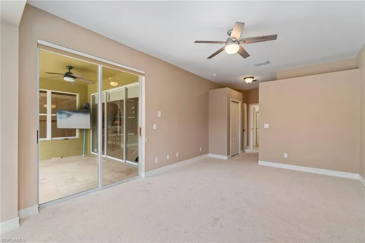 Unfurnished room with a ceiling fan and carpet