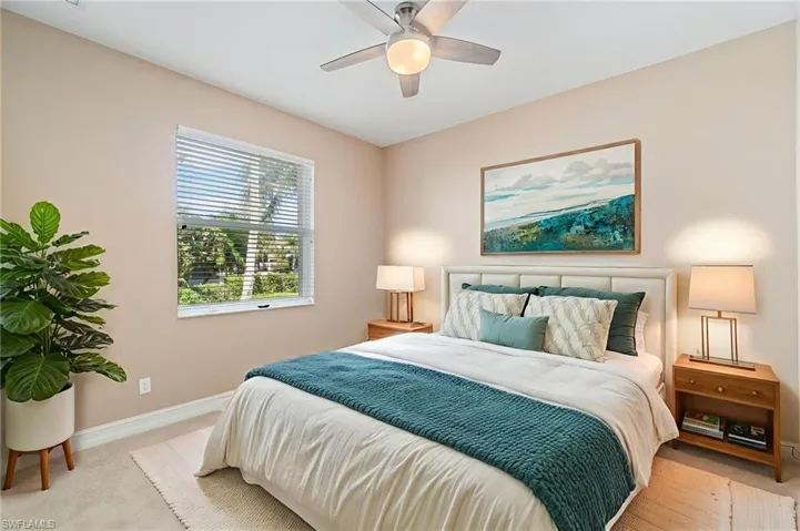 Bedroom featuring light carpet and ceiling fan