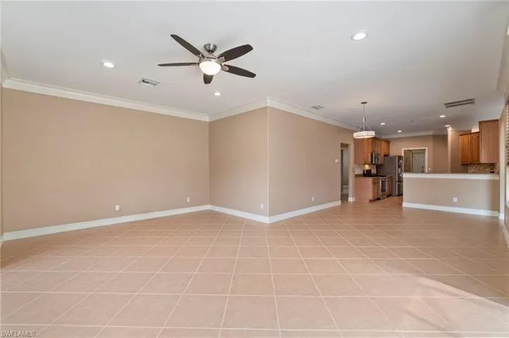 Unfurnished living room featuring ornamental molding, a ceiling fan, light tile patterned flooring, and recessed lighting