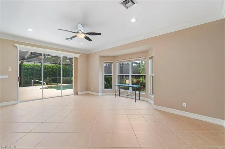 Spare room featuring a ceiling fan, crown molding, light tile patterned floors, and recessed lighting