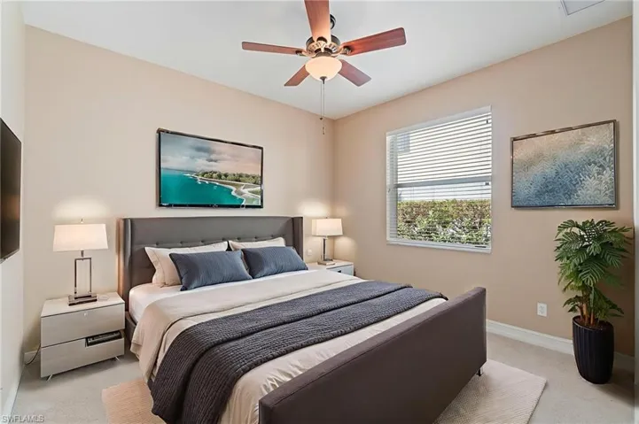 Bedroom featuring light colored carpet and ceiling fan