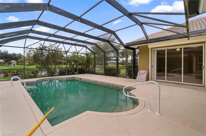 Swimming pool featuring a patio area and a lanai