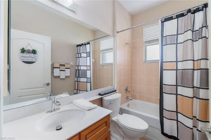 Full bath with vanity and shower / bath combination with curtain